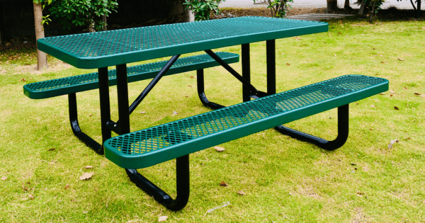 A Green Picnic Table With Benches